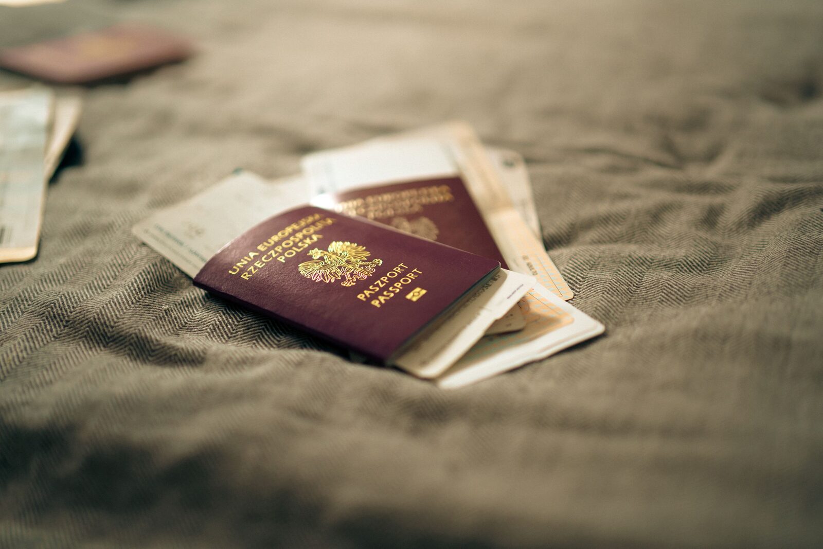 A Polish passport alongside travel documents and boarding passes