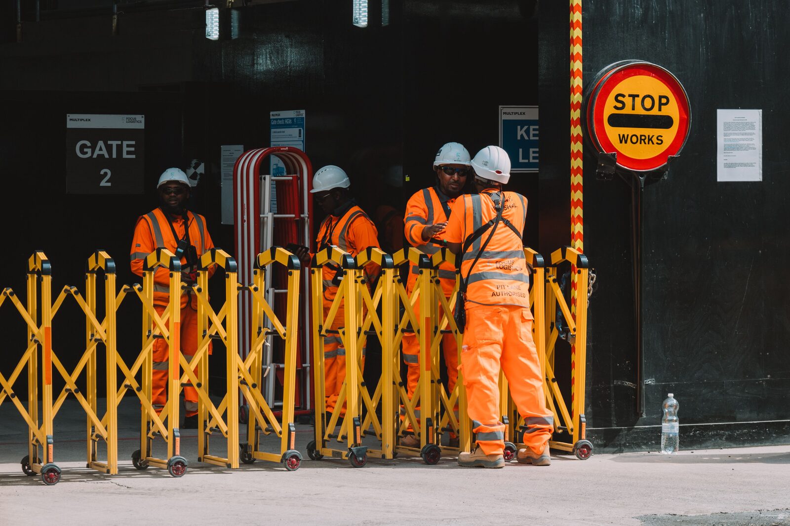Construction workers in high-visibility gear at a building site